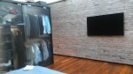 tv installed on brick wall